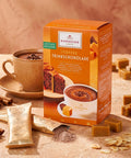 Niederegger Toffee Trinkschokolade in orangefarbener Packung, mit Schokoladenstücken