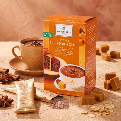 Niederegger Toffee Trinkschokolade in orangefarbener Packung, mit Schokoladenstücken